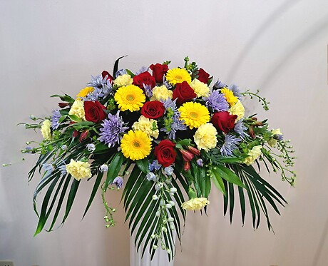 Red, Yellow, and Blue Casket Spray