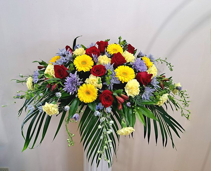Red, Yellow, and Blue Casket Spray